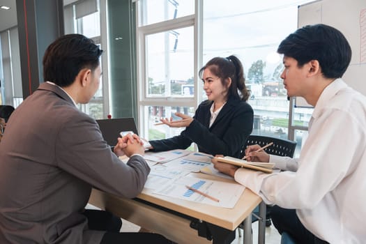 The Asian business team brainstormed and discussed work planning. Financial or statistical figures of the company in the conference room.