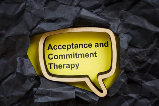 Acceptance and commitment therapy concept. Torn dark paper and speech bubble.