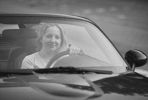 Attractive woman in a cabriolet in the Netherlands.