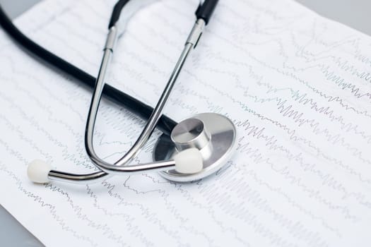 Ambulance, EEG graph and stethoscope on gray background close up