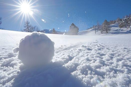 Snowball on snow covered ground at sunny winter day for snow ball effect concept. Neural network generated image. Not based on any actual scene or pattern.