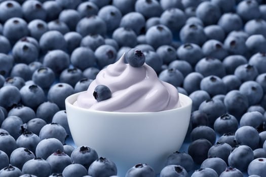 Soft serve blueberry ice cream in a white bowl surrounded by fresh blueberries.