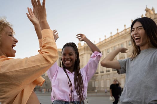 Group of young multiethnic people with raised Hands to the Sky to work as a team and support each other.