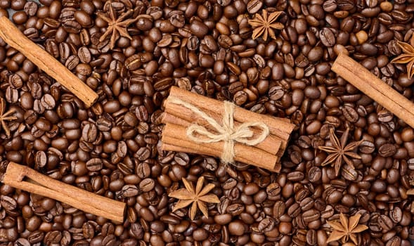 Roasted coffee beans, cinnamon sticks and star anise, full frame