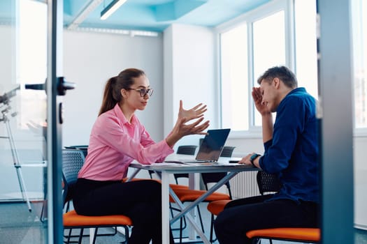 A furious business director of a startup office berating her employee for business mistakes and errors.