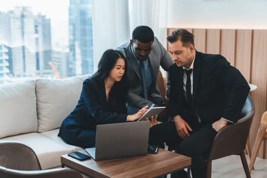 Group of skilled multiethnic businesspeople looking at data analysis by using tablet. Group of smart manager sharing, brainstorming, discussing, thinking about marketing strategy, idea. Ornamented