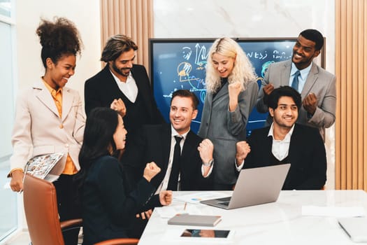 Multicultural businesspeople brainstorming business idea together. Diverse professional business team working together, sharing, planing idea, strategy. Meeting room, laptop, presentation. Ornamented.