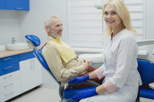 Male smiling during her dental treatment at dentist.