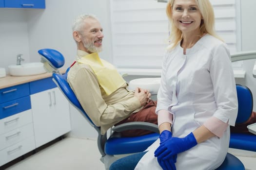 Male smiling during her dental treatment at dentist.