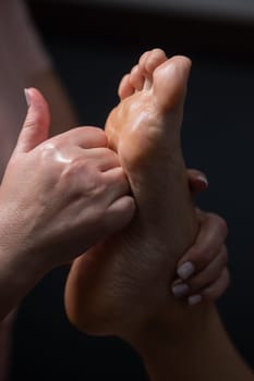 Close-up of a woman's foot massage. Vertical photo