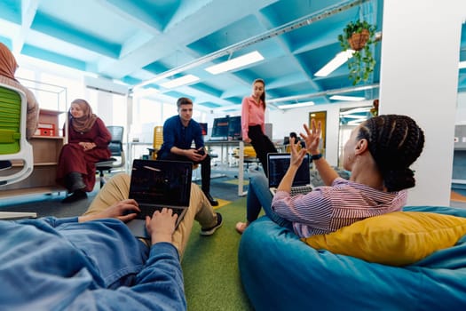 A diverse group of professionals engages in vibrant collaboration, exchanging innovative ideas and fostering creativity within the dynamic setting of a modern startup office.