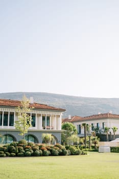 Green garden with flowering bushes near the villas of the One and Only hotel. Portonovi, Montenegro. High quality photo