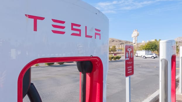 Primm, Nevada, USA-December 3, 2022-During the day, a Tesla vehicle is seen charging at a Tesla Supercharging station, utilizing the high-speed charging infrastructure for convenient and efficient electric vehicle refueling.