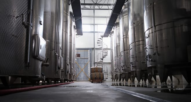 Modern winery interior with large metal tanks. Production and line of industrial chemical tanks in chemical pharmaceutical production
