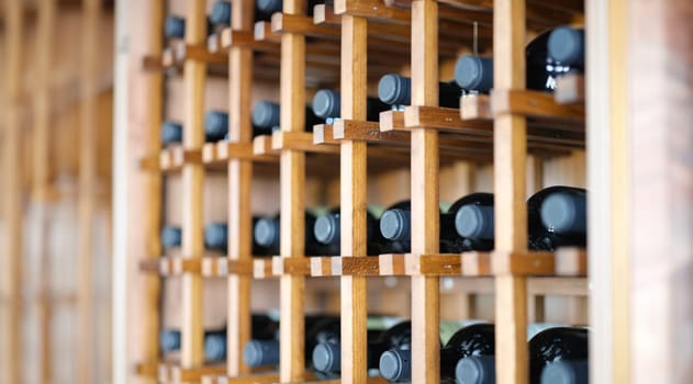 Homemade wine cellar with wooden boxes for storing bottles. Storage of elite wine concept