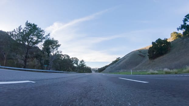 Basking in the beauty of a sunny winter day, driving on HWY 1 near Las Cruces, California offers stunning views of the picturesque coastal landscape against a backdrop of clear blue skies.