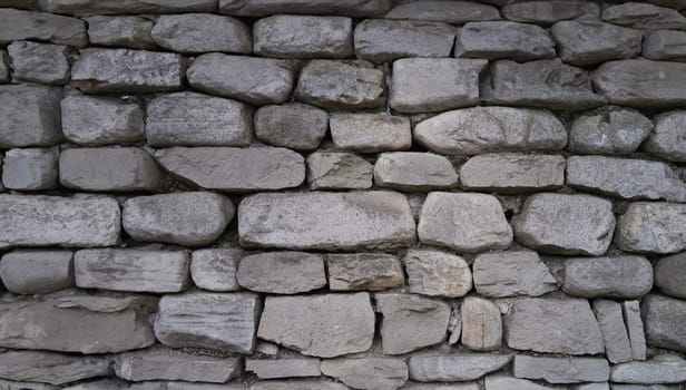 Stone old wall fencing seamless texture closeup. Background stones