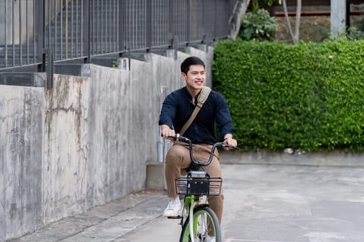 Eco friendly, Happy lifestyle asian young businessman ride bicycle go to office work at city street with bicycle in morning.