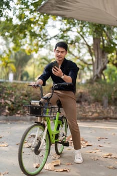 Businessman and bicycle in city to work with eco friendly transport. bike and happy businessman professional talking, speaking and telephone discussion while on in urban street.