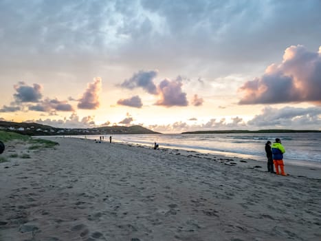 20 man are competing in a fishing competition on the beach