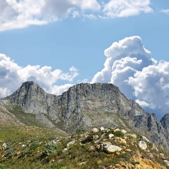 Mountain, blue sky and scenery with clouds, travel location and journey in natural landscape. Nature, landmark and environment for outdoor adventure, explore and holiday destination in Cape Town