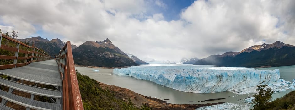 Stunning photo captures the grandeur of Perito Moreno Glacier from an elevated viewpoint trail.