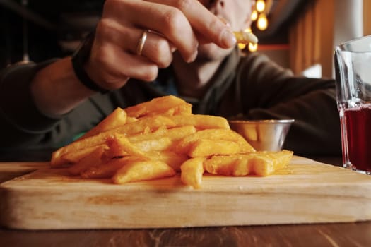 Close-Up of French Fries on Cutting Board, selective focus