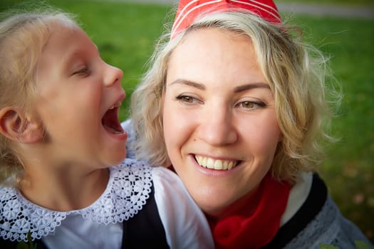 Young and adult schoolgirl on September 1. Generations of schoolchildren of USSR and modern Russia. Female pioneer in red tie and October girl in modern uniform. Daughter and Mother having fun