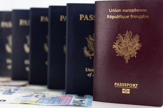 United States and France passports on currency transparent background. Base low camera angle, passports marching into background. Concept of business, trade, employment, vacation travel. Concept coming summer Olympics travel. Closeup, selective focus photo high quality photo.
