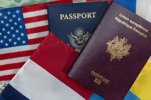 United States and France passports on Euro currency and French, American, Russian and Ukraine flags. Flat lay. Concept of business, trade, employment, vacation travel. Concept coming summer Olympics and conflict. Closeup photo high quality photo.