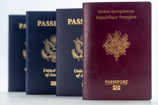 3 United States and 1 French passports on transparent background. Concept of business, trade, employment, vacation travel. Concept coming summer Olympics travel. Straight on closeup, selective focus photo high quality photo.