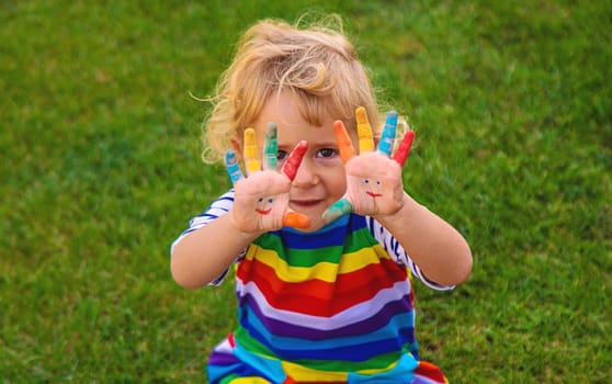 Child in hand draw smile. Selective focus. Kid.