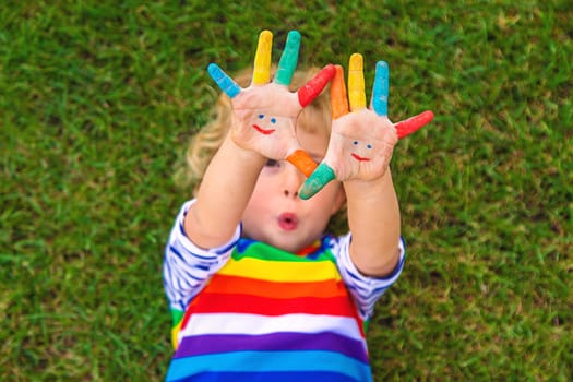 Child in hand draw smile. Selective focus. Kid.