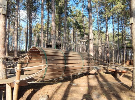 rope sports play park with suspended wooden structures on sunny day