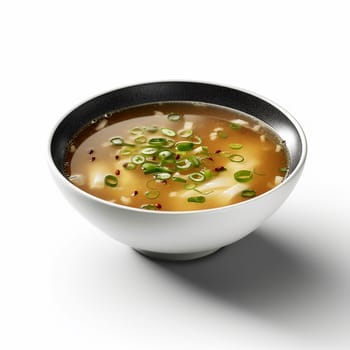 A bowl of clear soup with green onions