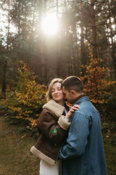 Adult couple is sharing hugs surrounded by the beauty of nature.