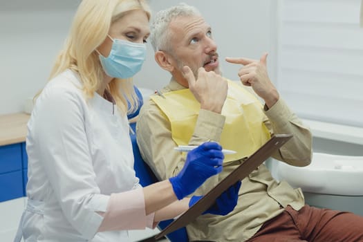 Male smiling during her dental treatment at dentist.