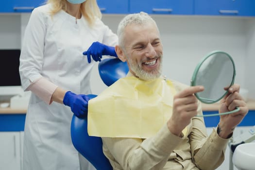 Male smiling during her dental treatment at dentist.