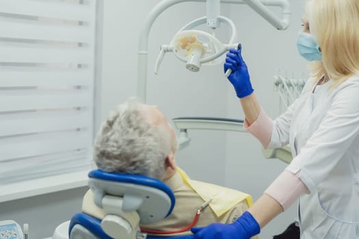 Male smiling during her dental treatment at dentist.