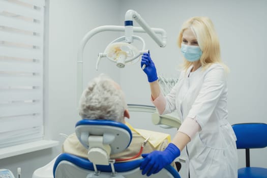 Male smiling during her dental treatment at dentist.