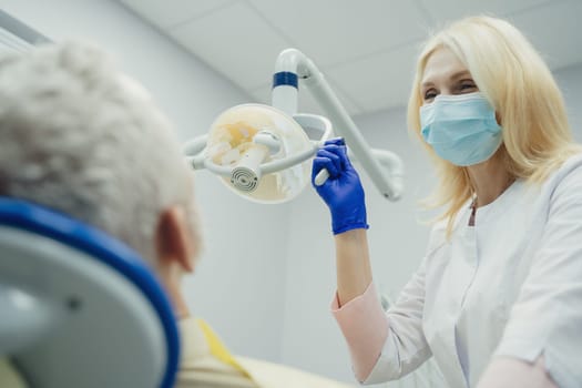 Male smiling during her dental treatment at dentist.