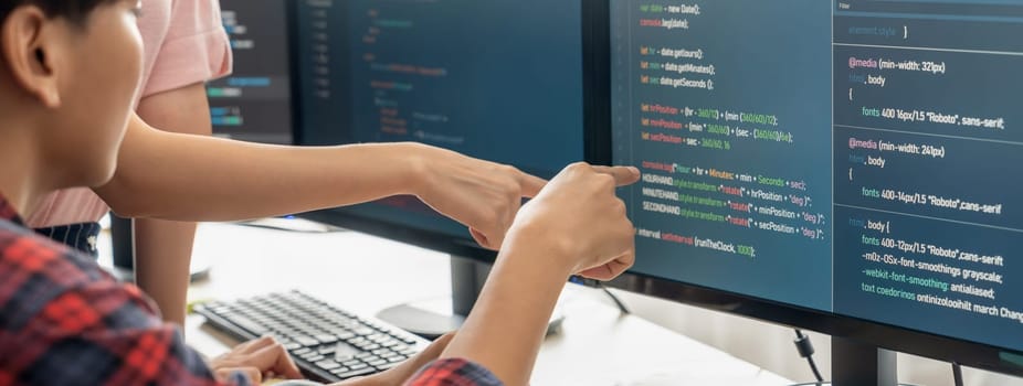 Cropped image of professional programer team collaboration discuss about web coding while coworker point java script displayed on computer at modern company office. Closeup. Burgeoning.