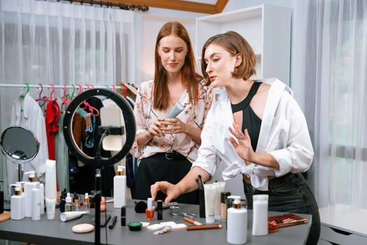 Woman influencer shoot live streaming vlog video review makeup utmost social media or blog. Happy young girl with cosmetics studio lighting for marketing recording session broadcasting online.