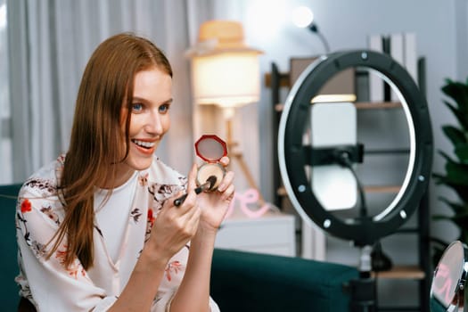 Woman influencer shoot live streaming vlog video review makeup utmost social media or blog. Happy young girl with cosmetics studio lighting for marketing recording session broadcasting online.