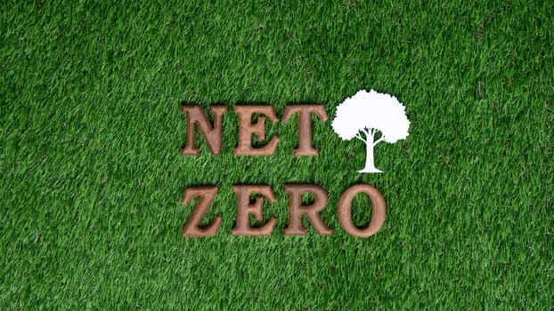 Environmental awareness campaign showcase message arranged in Net Zero on biophilic green grass background. Environment friendly with reduce CO2 emission concept for sustainable and green future. Gyre