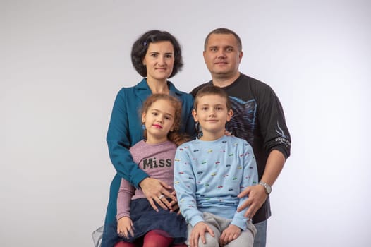 studio portrait of a happy family husband wife daughter and son 12