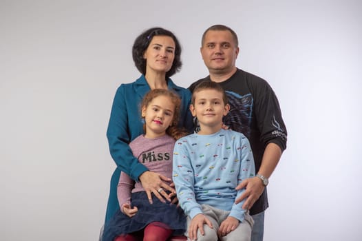 studio portrait of a happy family husband wife daughter and son 11