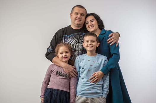 studio portrait of a happy family husband wife daughter and son 3