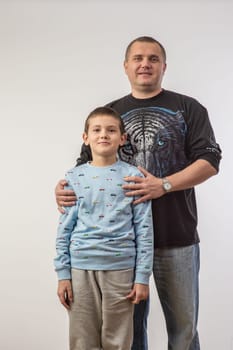 Portrait of dad playing with his son isolated on white 1