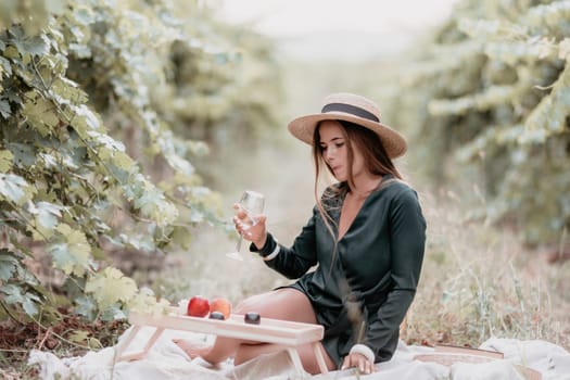 Picnic and wine tasting at sunset in the hills of Italy, Tuscany. Vineyards and open nature in the summer. Romantic dinner, fruit and wine.